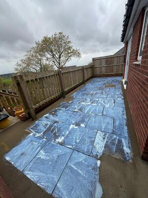 SBR bonding applied to concrete patio slabs prior to resin surfacing being laid in property in l;oghor Swansea RNM Resins