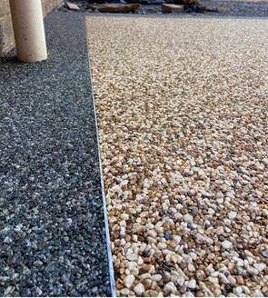 Close up view of completed resin patio installation in sage grey border and sand storm centre at Pontardawe Swansea by RNM Resins