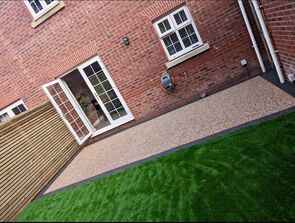 Rear photo of completed resin patio installation by RNM Resins including a newly turfed garden in property in Pontardawe Swansea.