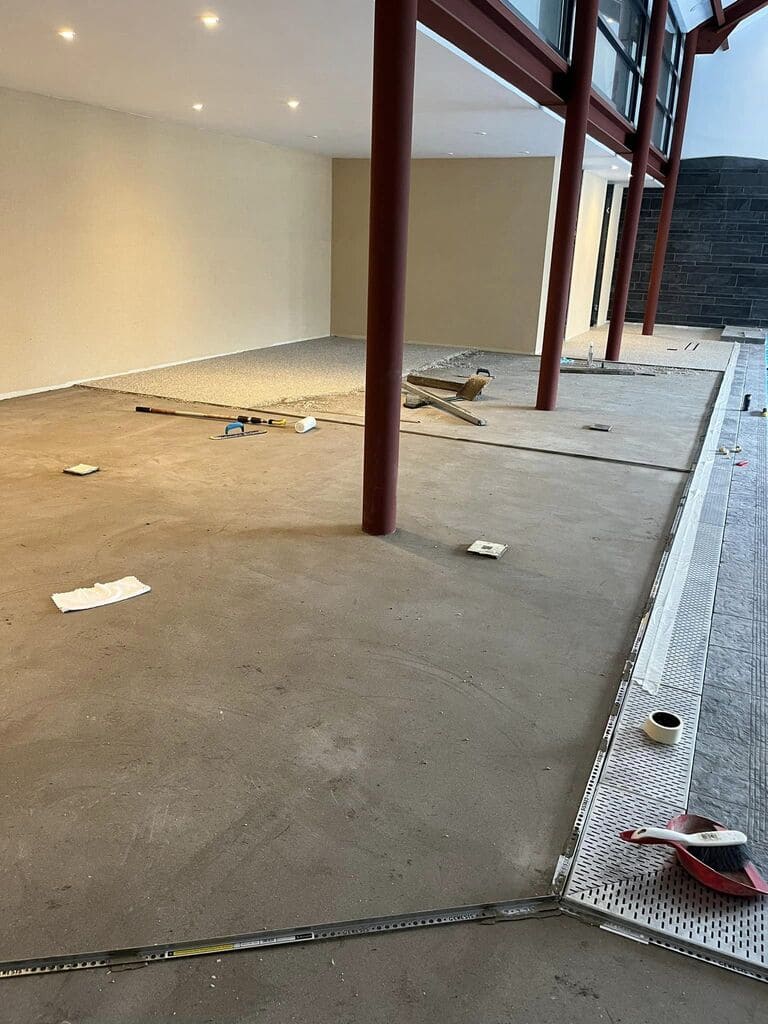 Edging strips laid on screed floor in readiness for Lavender preson surfacing on pool surround at Pantyffynon Ammanford by RNM Resins