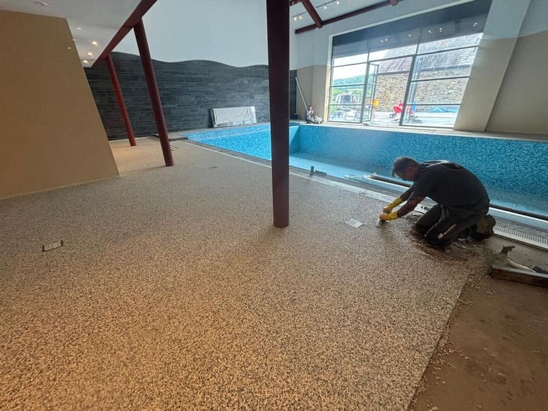 Meticulous laying by RNM Resins Installers for pool surround in Panyffynon Ammanforf