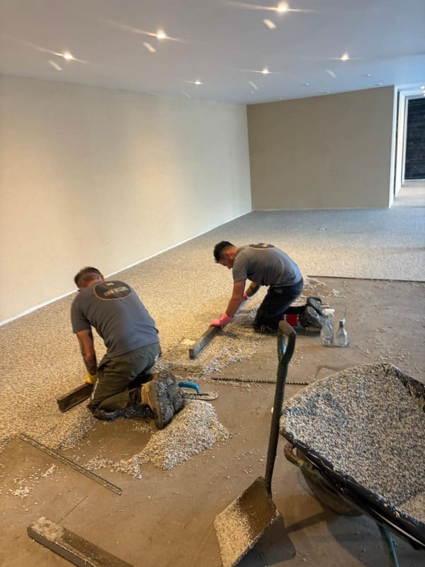 RNM Resins specialist team busy laying resin surfacing for pool surround in Pantyffynon Ammanford